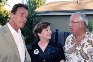 California Governor Arnold Schwarzenegger and Martha Marks listen as State Senator Tom Harman speaks.