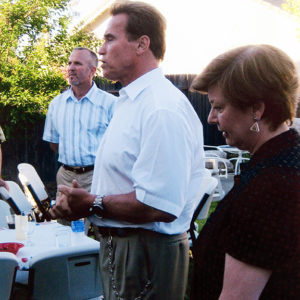 California Governor Arnold Schwarzenegger speaks as Martha Marks and other REP members listen.